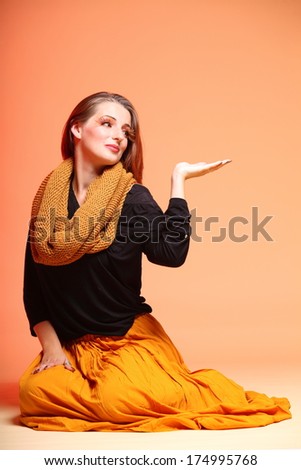 Fall. Fashion woman in autumn color fresh girl in full length long false orange eye-lashes