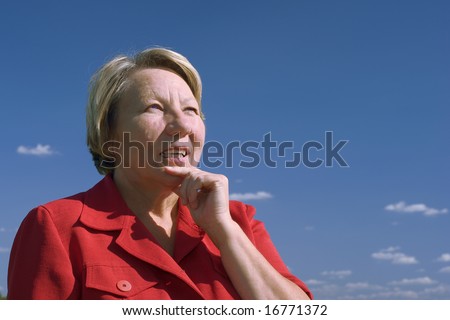 This is a portrait of a mature-aged woman  to think on blue sky