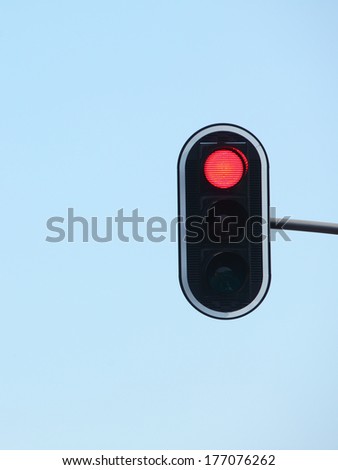 Red traffic lights against blue sky backgrounds