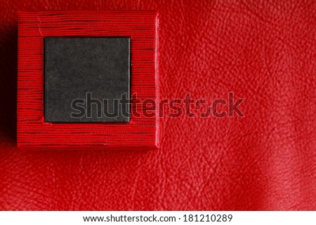 Red black rectangular ring jewellery box on leather background