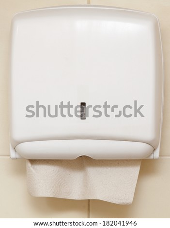 Paper towel dispenser on the wall in the bathroom