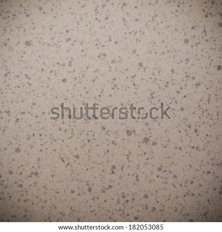 Closeup of beige brown spotted texture as background backdrop pattern, vignette.  Square format.