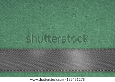 Empty banner on vintage background. Gray ribbon on green fabric cloth texture with copy space.