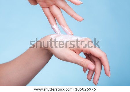 Skincare. Closeup of female hands. Young woman girl taking care of her dry hands palms applying moisturizing cream. Beauty treatment.