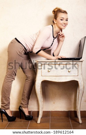 Technology internet modern lifestyle. Full length of young businesswoman woman student girl working on computer laptop at the retro desk. Business at home.