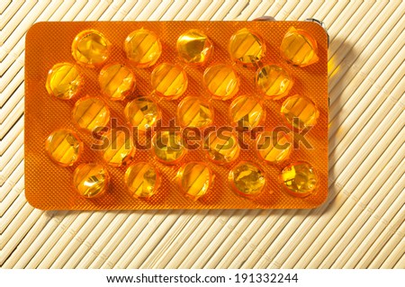 Closeup of orange package of pills tablets drug medicine. Health care and addiction.