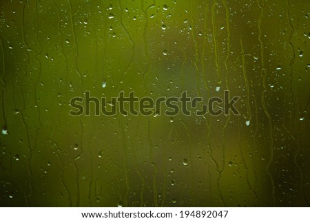 Closeup of water drops droplets raindrops on glass window as background texture. Rain.