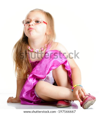 Full length a cute girl sitting on floor puffs up her cheeks on white background