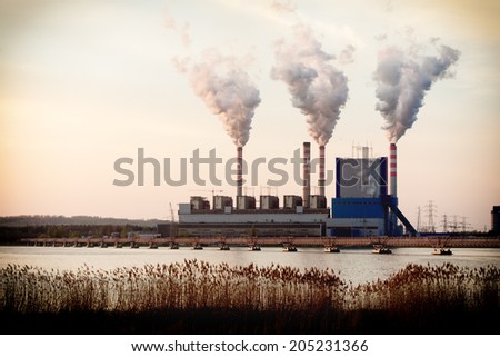 Energy. Smoke from chimney of power plant or station. Industrial landscape.