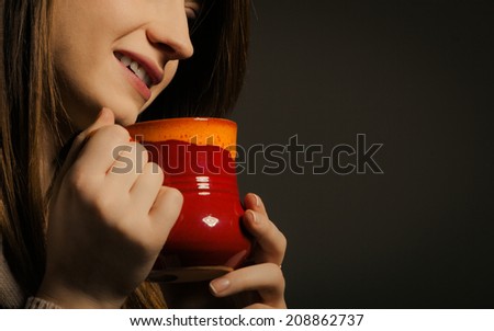 Hot beverage. Closeup of girl drinking cup mug of drink tea or coffee. Woman warming herself
