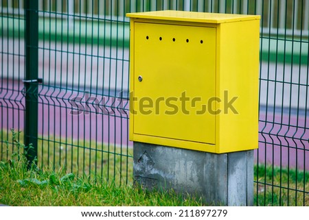 Yellow electric control box outdoor. Urban power and energy. Supply electricity.