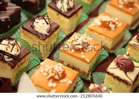 Varieties of cakes individual decorative desserts on the table at a luxury event, gourmet catering sweets