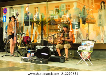 BERGEN, NORWAY - JULY 25, 2014: Gee Gee Kettel and Soluna Samay play on street during The Tall Ships Races in city Bergen on July 25, 2014, Norway. One Man Band and World Traveller