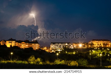 thunderstorm over night city with massive lightning bolt