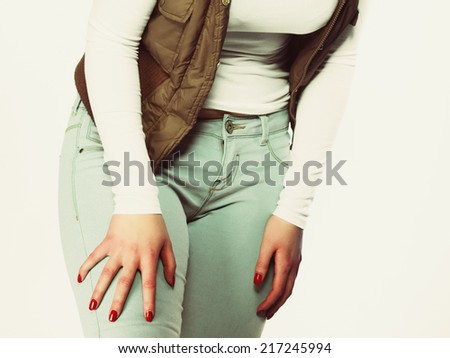 Fashion casual style. Part of body, female hips. Sexy plus size woman in jeans studio shot.