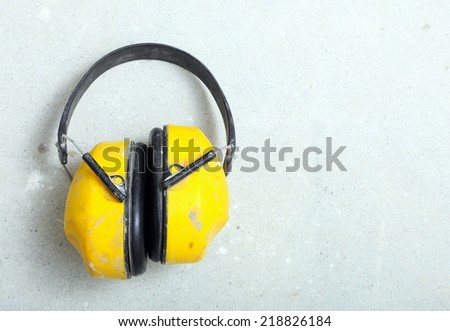 Ear hearing protection. Yellow working protective headphones noise muffs, toolwork in construction site