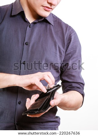 Finance and economy. Young man with wallet paying by credit card spending money. Buy and retail sell. Isolated on white. Studio shot.