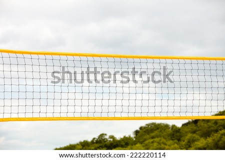 Volleyball summer sport equipment. Closeup of net netting wire on a sandy beach outdoor. Active lifestyle.
