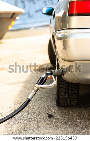 Auto refuel. Car at gas station being filled with fuel, fill up of liquefied petroleum gas, LPG