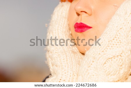 Winter fashion. Beauty face portrait redhaired young woman in warm clothing outdoor enjoying sunlight on sunny day.