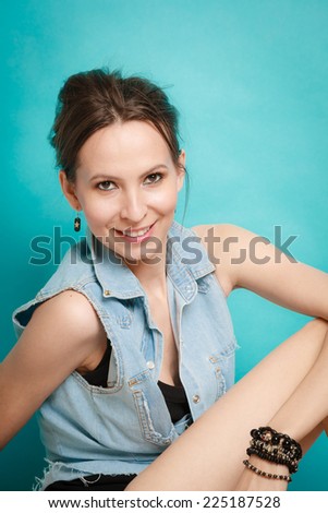 Vacation and summer fashion. fashionable girl in jeans shirt on blue