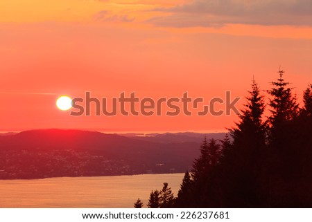 Panoramic view from hill of Bergen and fjord landscape red sky sunset scenery, Norway