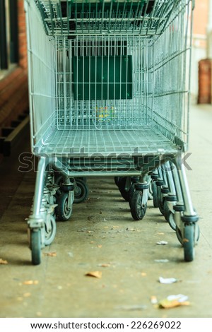 Row of empty shopping cart trolley. Market grocery shop and retail concept. Outdoor.