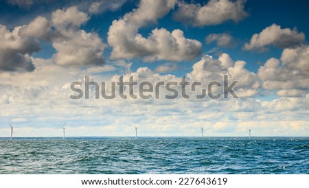 wind turbines power generator farm for renewable energy production along coast baltic sea near Denmark. Alternative green energy ecology.