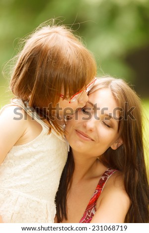 Happy family. Little girl daughter kid child hugging his mother expressing tender feelings. Love.