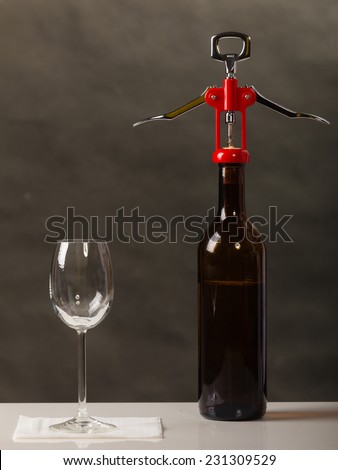 Opening of bottle of wine with corkscrew opener
