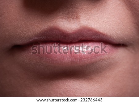 Closeup shiny glossy pink female lips. Part of face. Makeup and woman beauty.