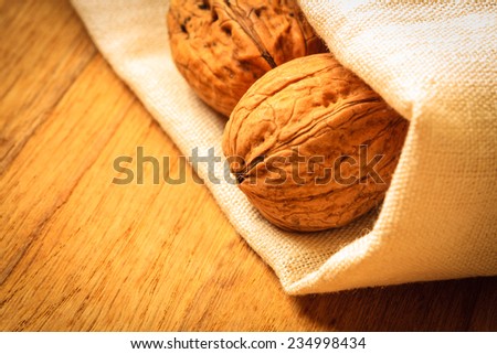 Healthy food full of omega-3 fatty acids, organic nutrition. Whole walnuts on rustic old wooden table