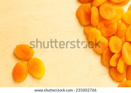 Healthy food organic nutrition. Border frame of dried apricots set fruit on wooden background