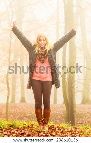 Happy woman walking relaxing in foggy day in romantic autumn forest park outdoor