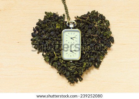Diet healthcare tea time concept. Green tea heart shaped on wooden surface. Healthy food drink for lower heart disease risk