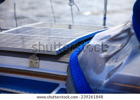 Solar charging batteries aboard a sail boat. Photovoltaic panels renewable eco energy concept