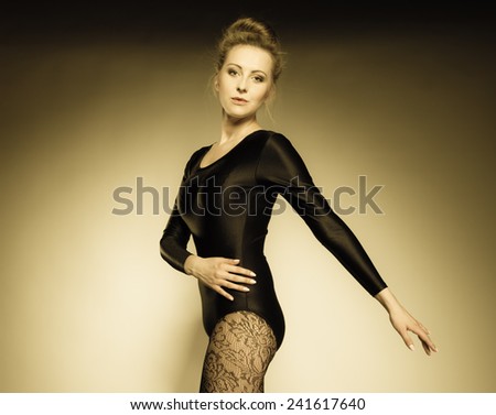Graceful beautiful woman ballet dancer studio shot sepia vintage aged tone