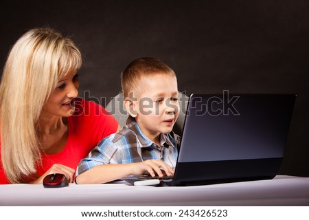 education, technology, internet and parenting concept - boy and mother with laptop computer