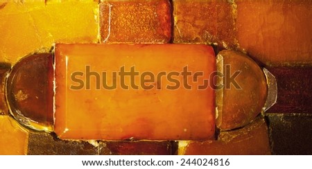 Macro. Closeup of amber mosaic as background texture or backdrop. Golden resin gem.