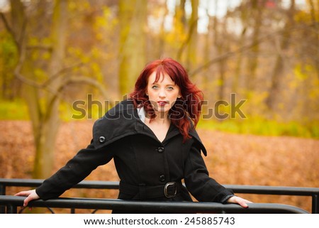 Fall lifestyle concept. fashion elegant young woman outdoor relaxing walking in autumn park