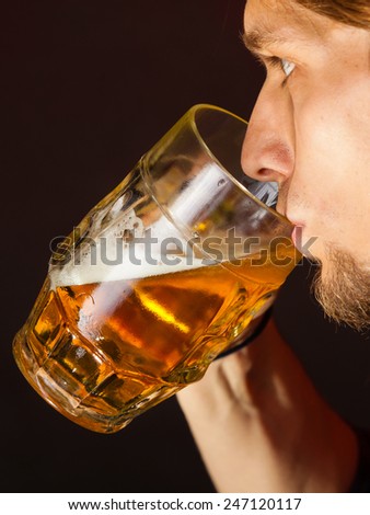 handsome young man guy drinking a glass of beer