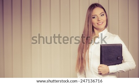 businesswoman holding document case. Elegant young woman blond girl with briefcase indoor. Corporate business. Sepia aged tone
