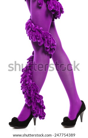 Female fashion. Woman long legs color purple stockings high heels and warm scarf around leg isolated