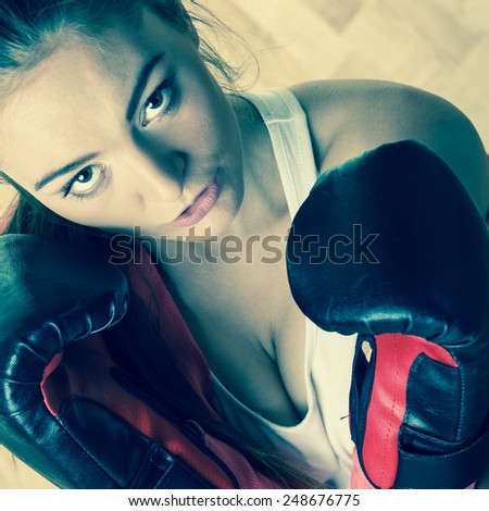 Emancipation and feminist. Defense concept. Young fit woman boxing. Indoor. Vintage instagram filter