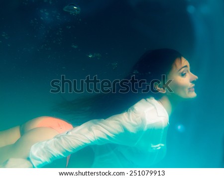 Leisure, relax and active lifestyle concept. Underwater girl wearing bikini swimming and diving