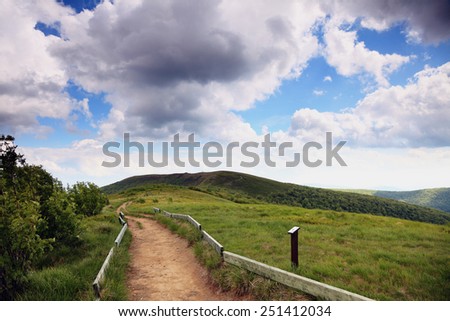 Nature and environment. Road in the beautiful green hills. Mountain landscape in the summer. Travel and tourism.
