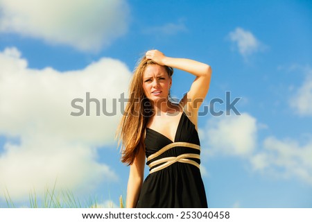 Little shocked woman on beach. Long hair girl model blue sky.