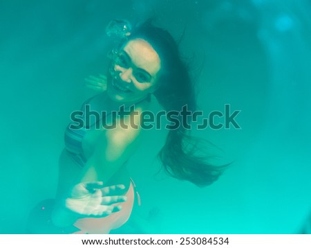 Leisure, relax and active lifestyle concept. Underwater girl wearing bikini in swimming pool