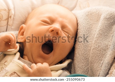 Closeup little newborn baby girl three weeks lying in diaper with open mouth