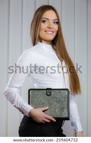 businesswoman holding document case. Elegant young woman blond girl with briefcase indoor. Corporate business.